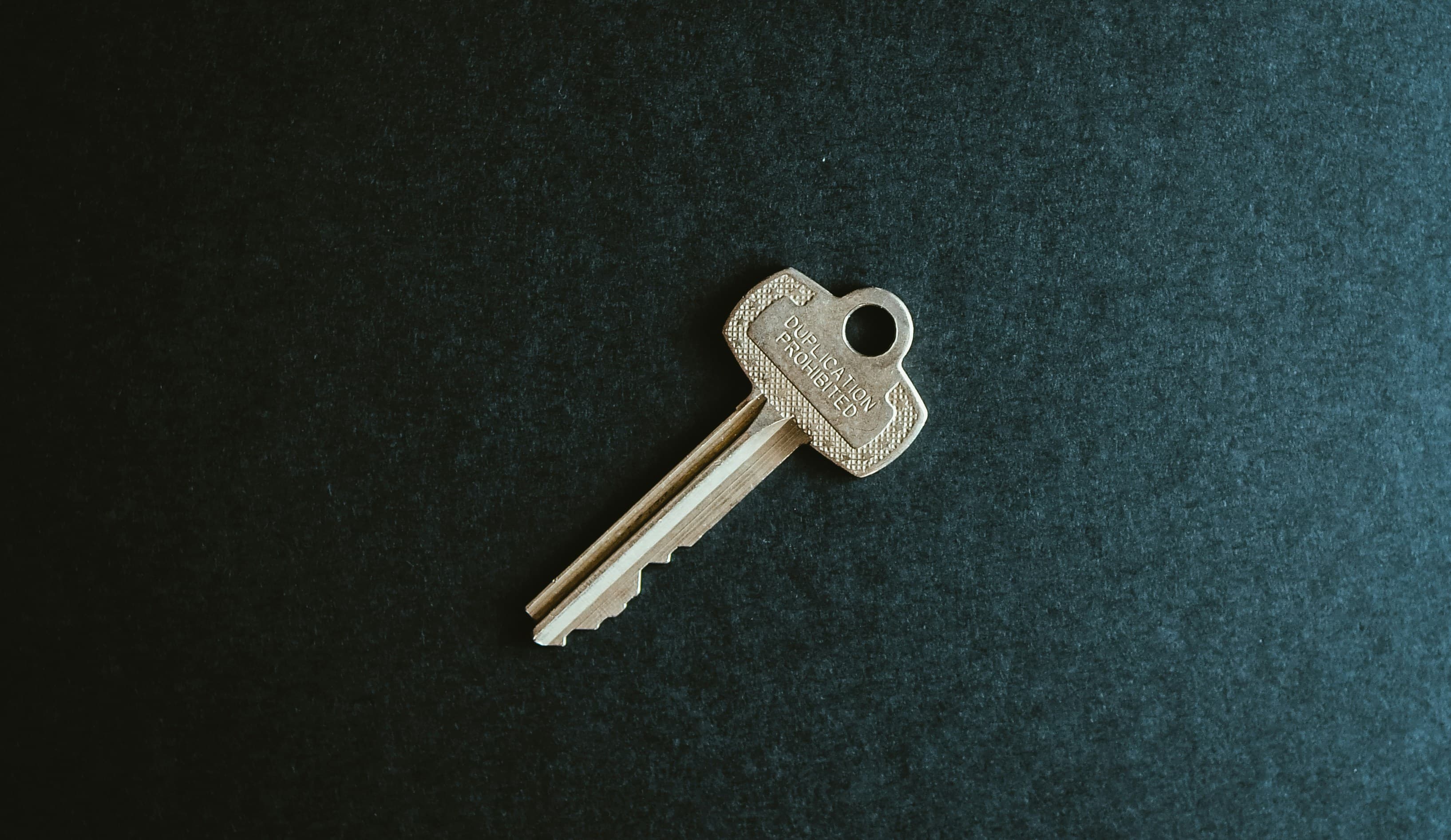 House keys resting on property paperwork, representing the conveyancing and searches stage of a home sale