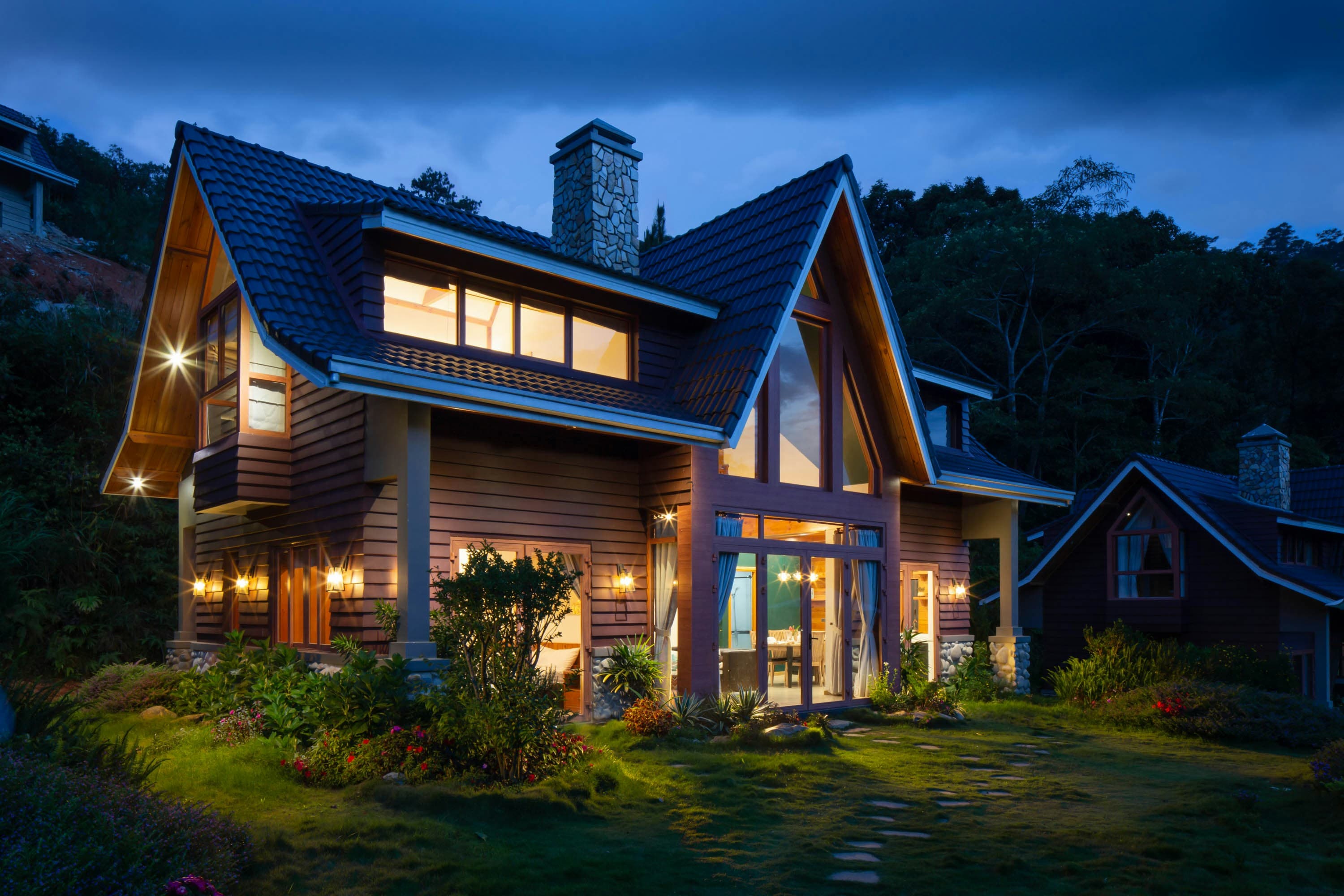 A modern house exterior on a quiet street, representing the decision of when to sell a home