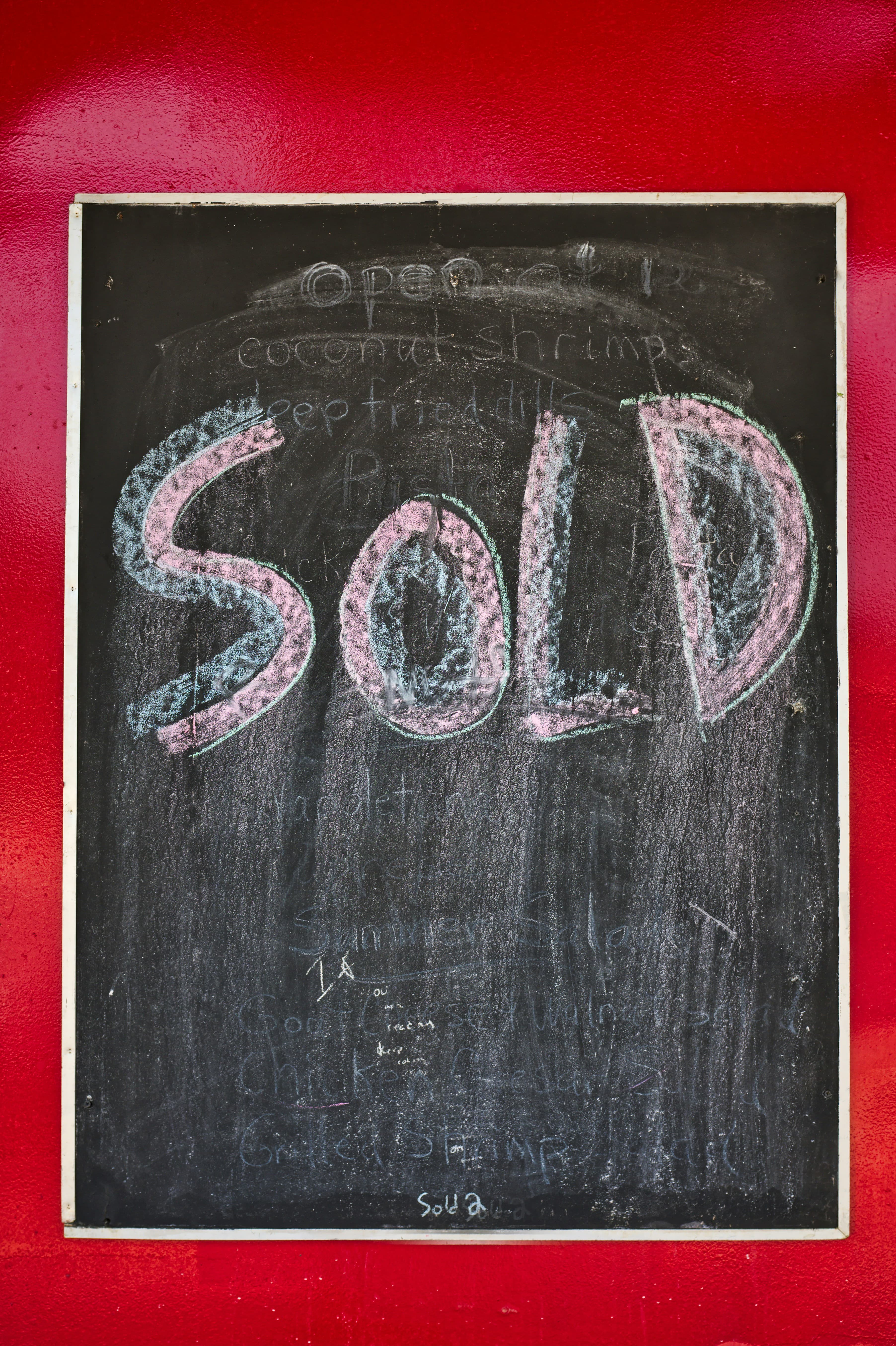 Estate agent For Sale and Sold board outside a UK property