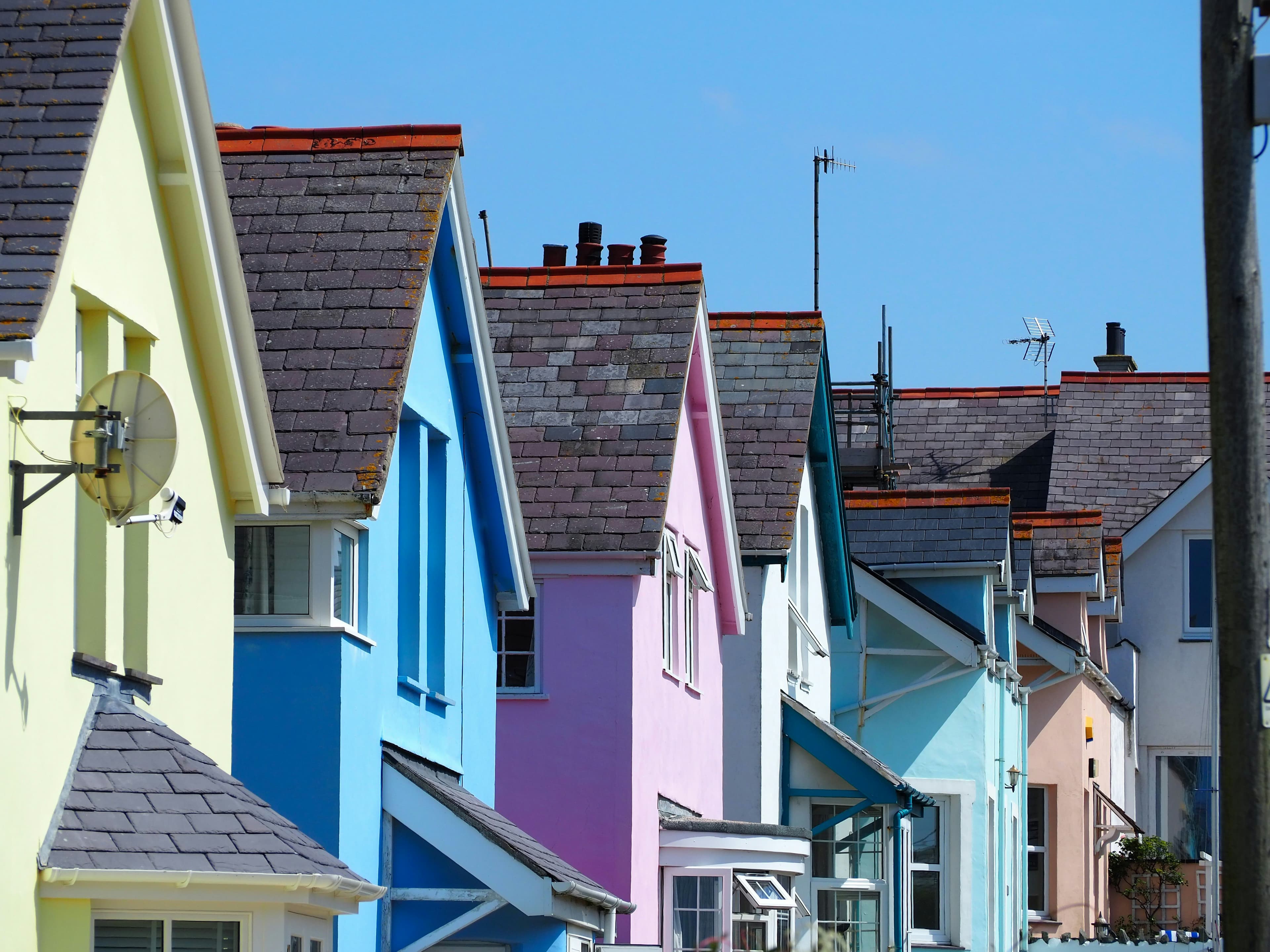Colourful seafront houses on a British coastal street under a cloudy sky