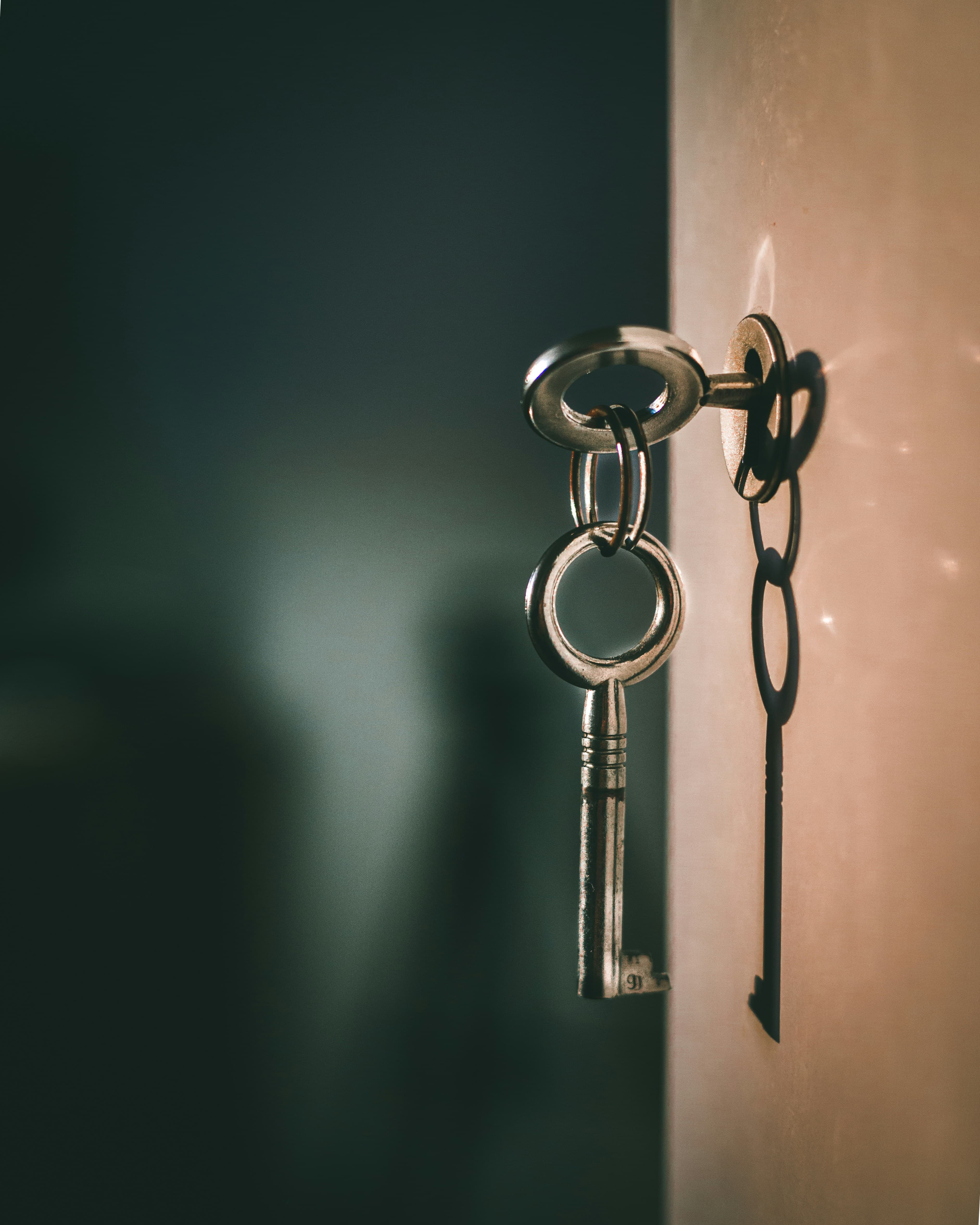 A set of house keys resting on a property contract, representing a sale in progress