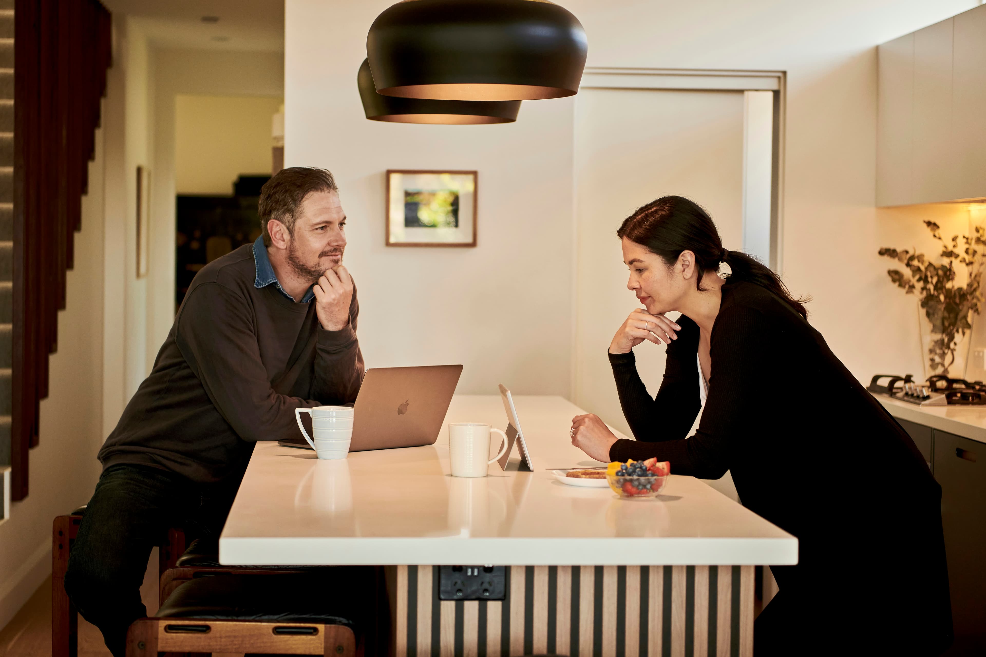 A person signing a property contract on a desk, representing an offer being put in writing