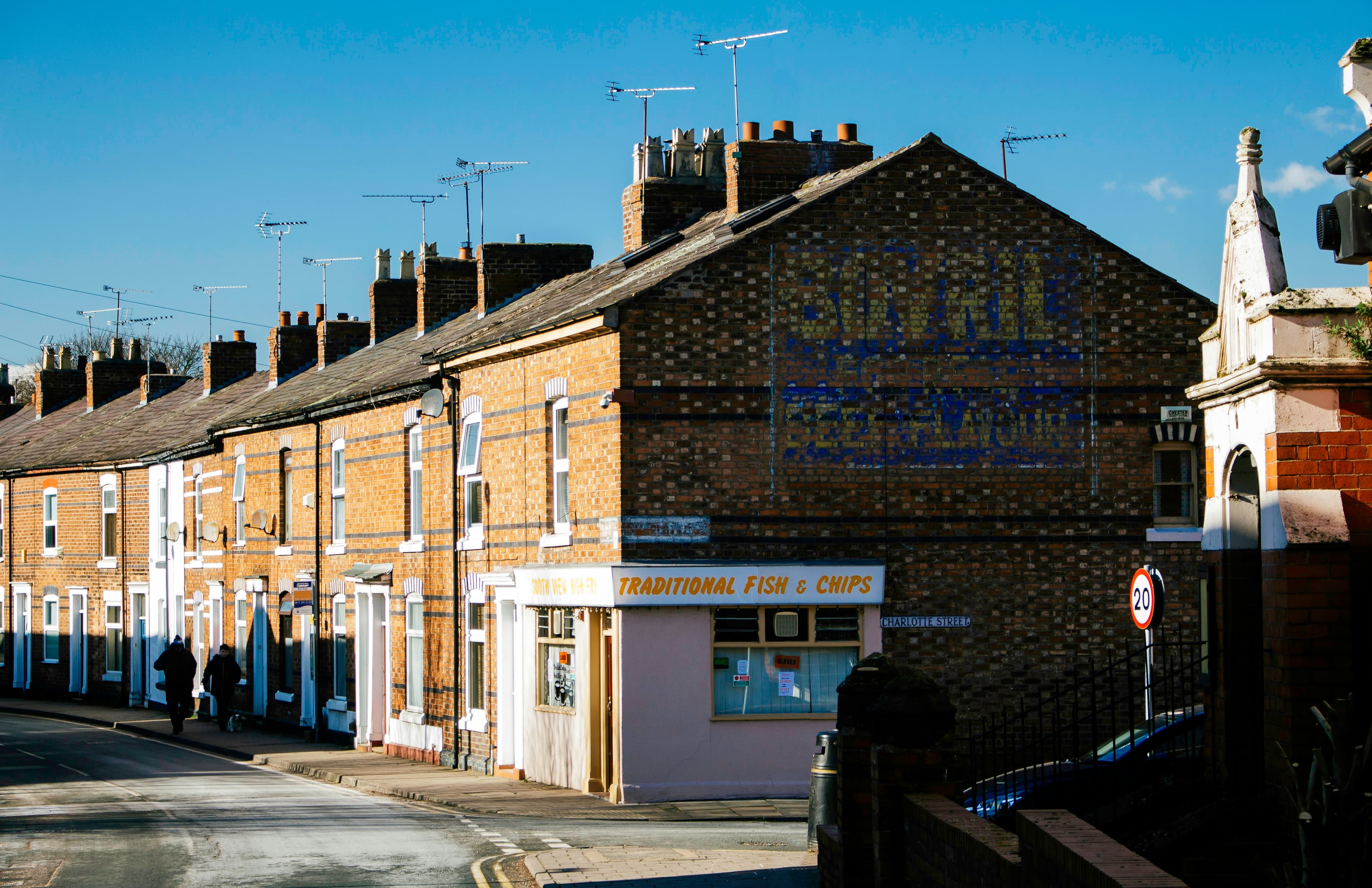 A street of UK houses on a sunny day, typical of a south Essex commuter town.
