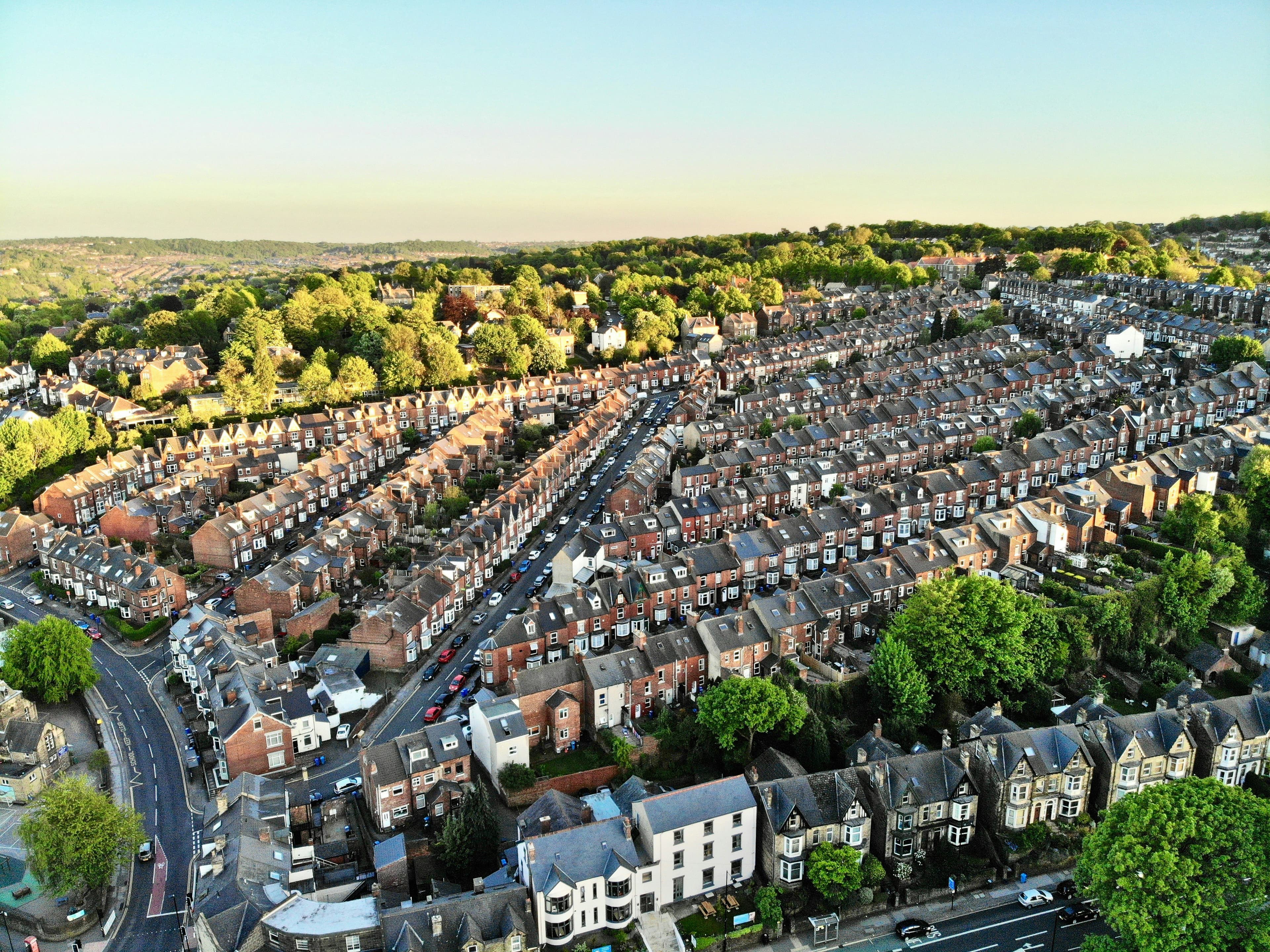 An aerial view of a residential area with many houses, representing sold-price data mapped across postcodes.