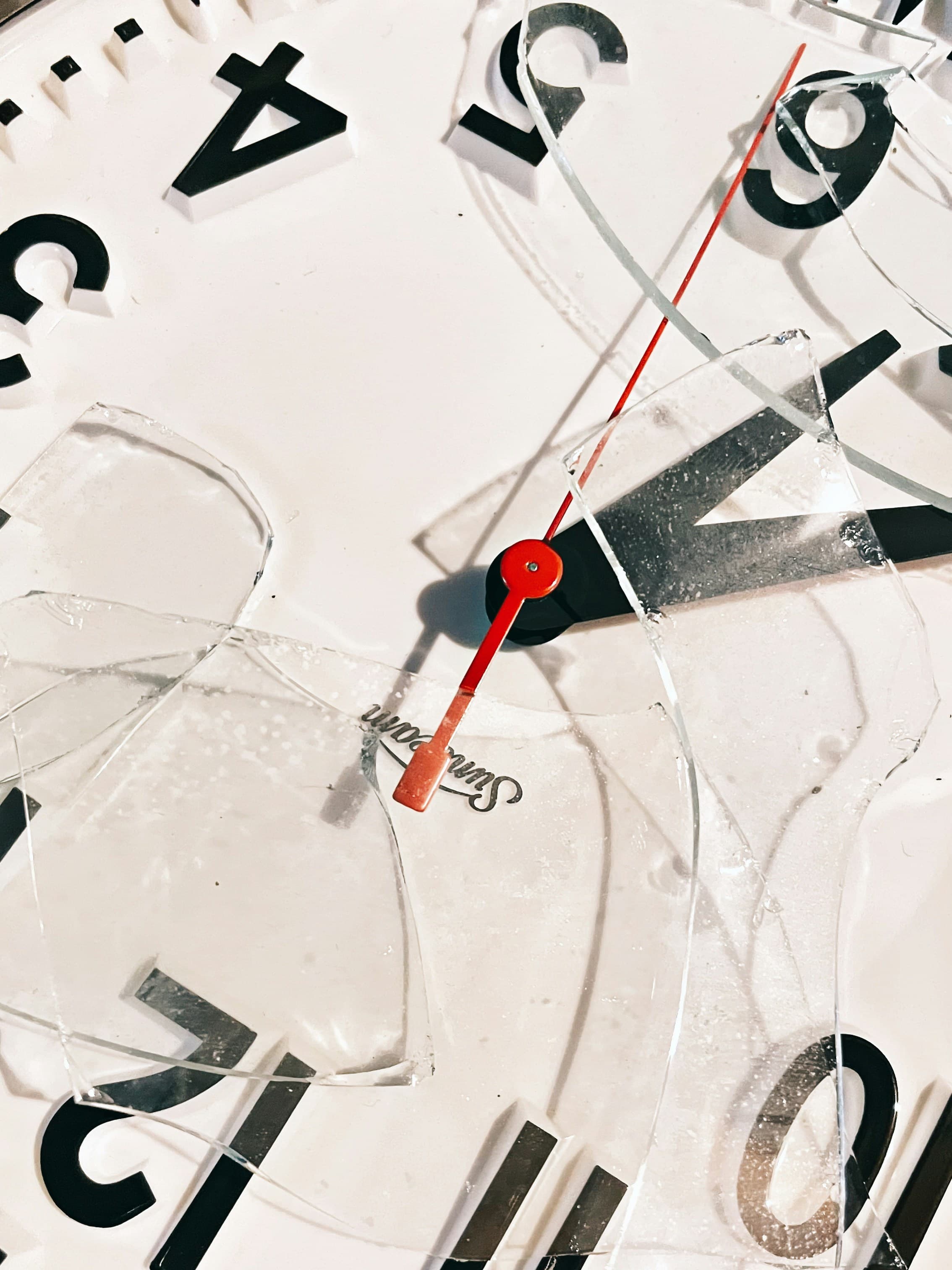 Close-up of an analog clock with a red second hand, representing the passage of time during a UK home sale.