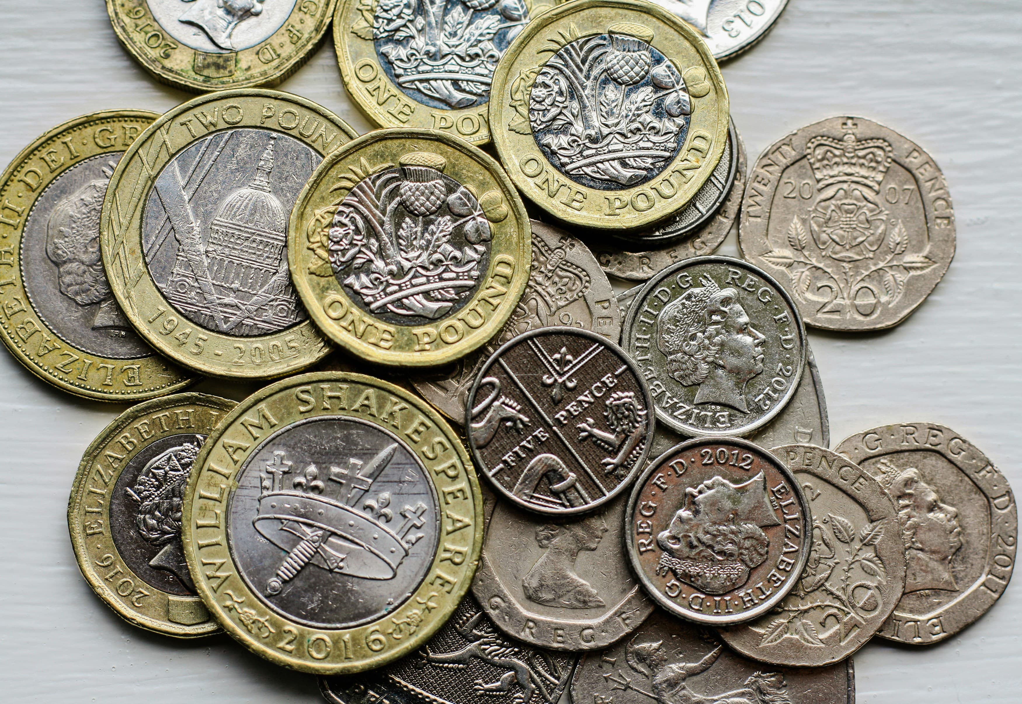 British coins arranged on a flat surface, representing the cost of selling a UK home.
