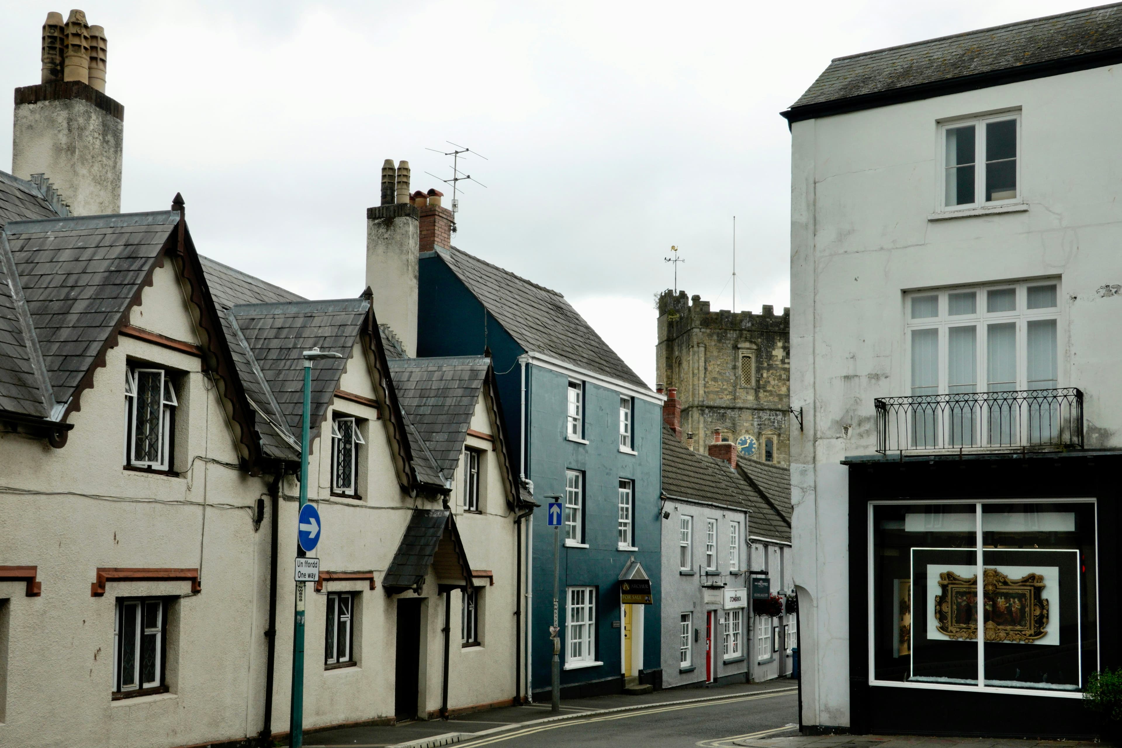 A row of terraced houses side by side along a residential street