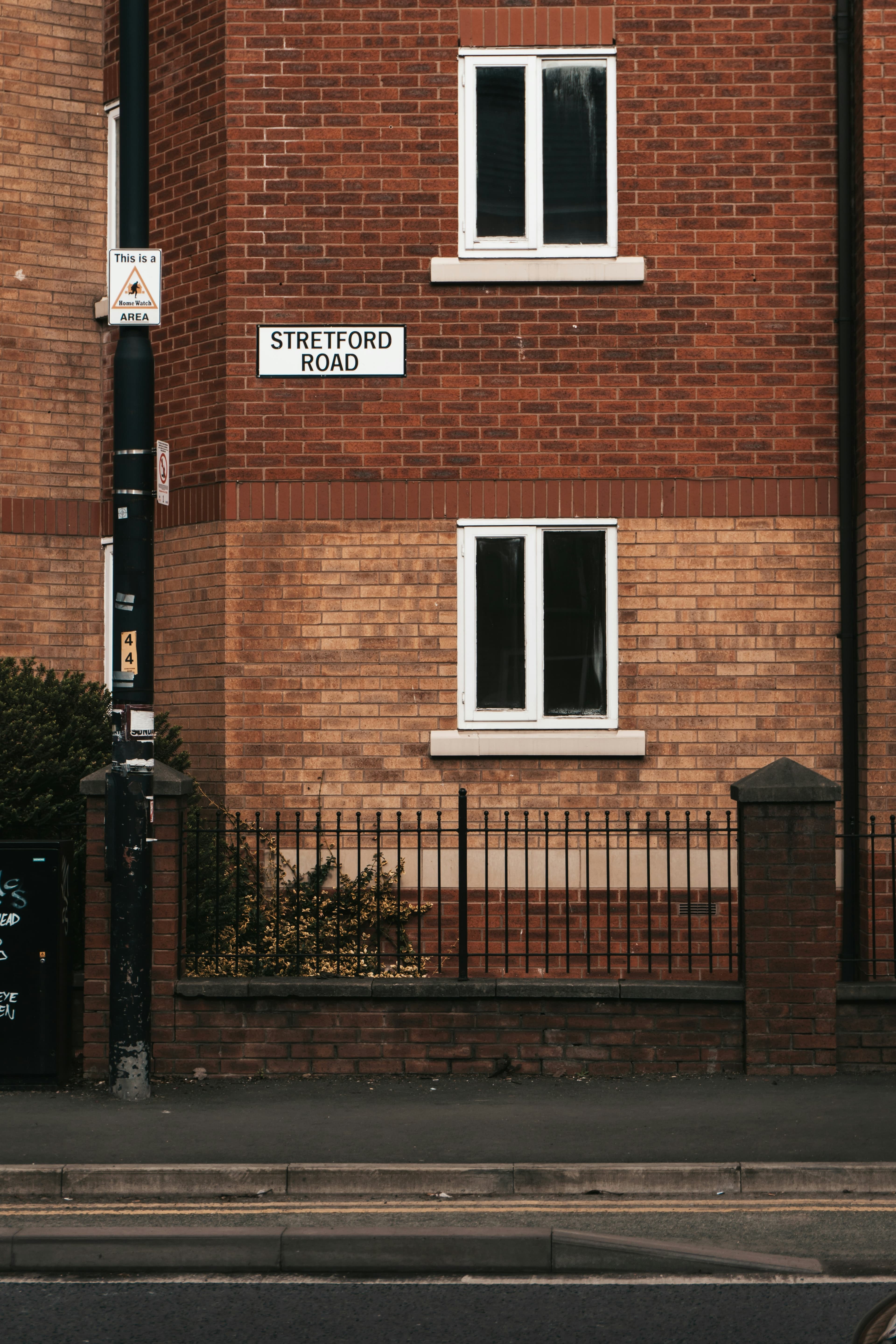Estate agent for sale boards outside UK homes on a residential street