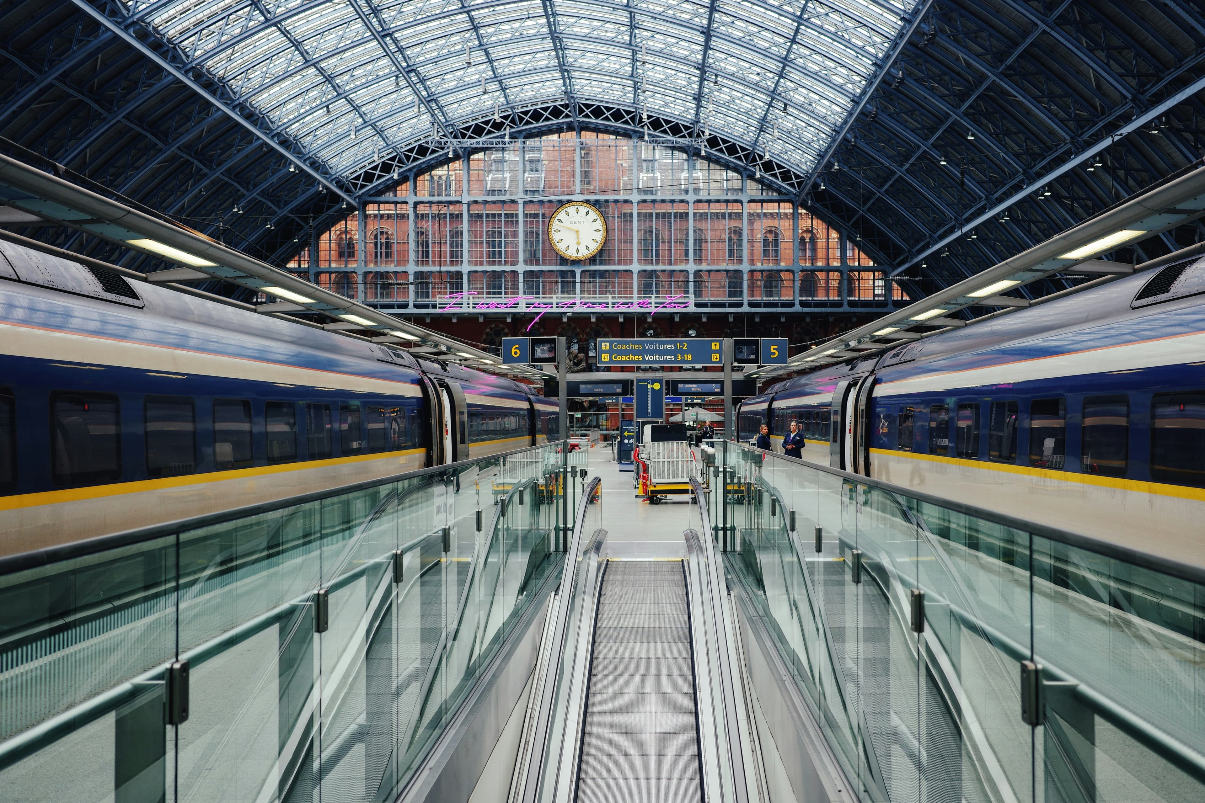 A commuter train passing through a London station, representing the c2c line into Fenchurch Street