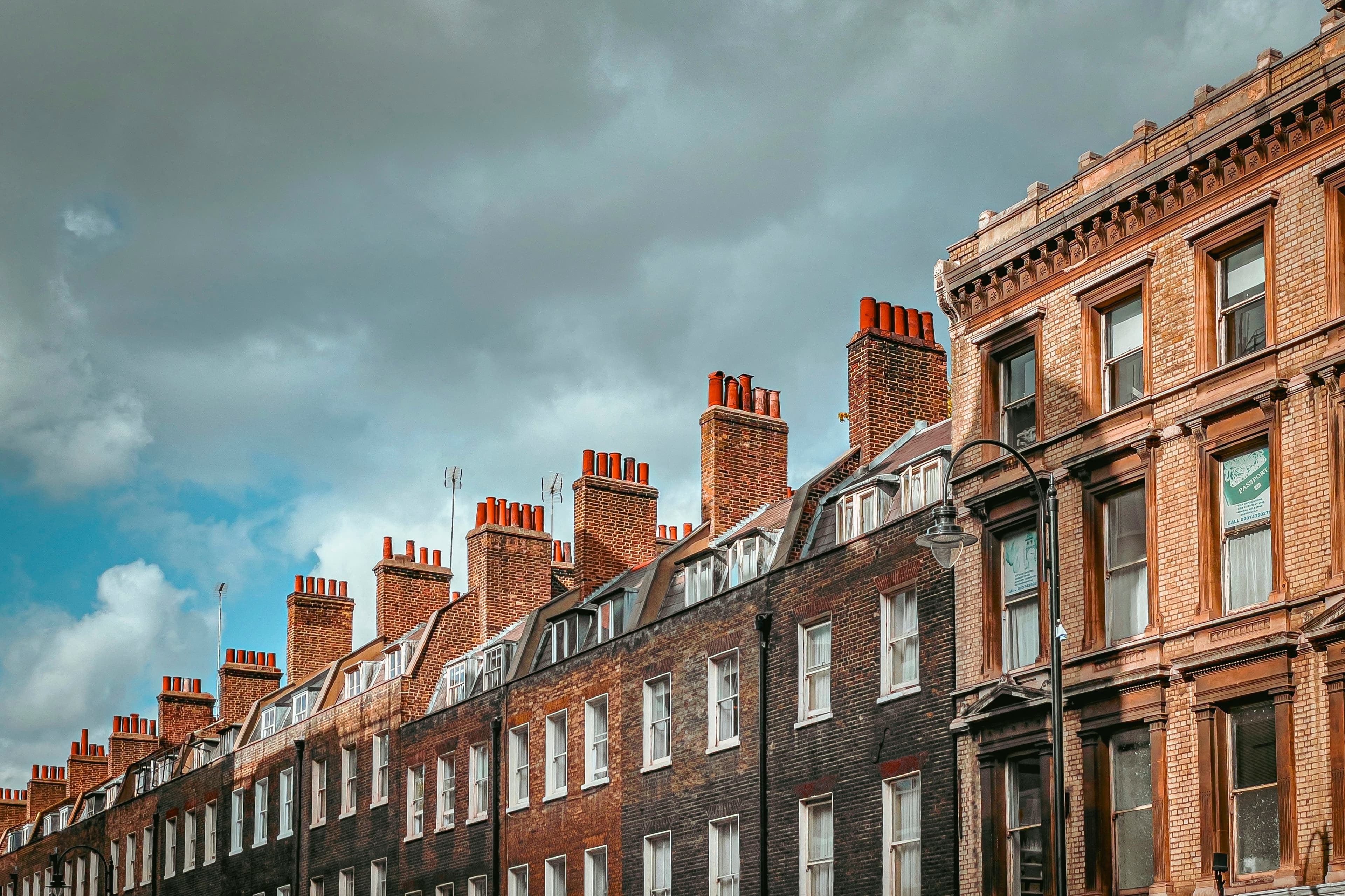 Row of British brick terraced houses on a cloudy day
