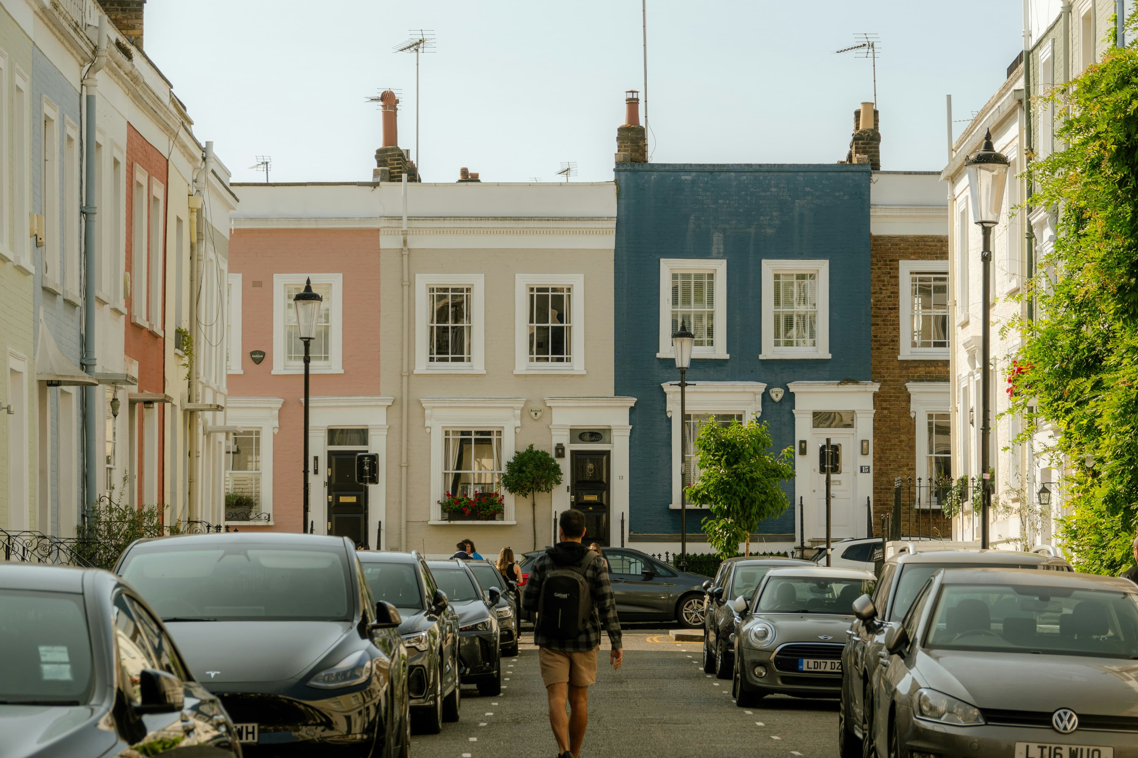 A row of traditional British terraced houses on a residential street
