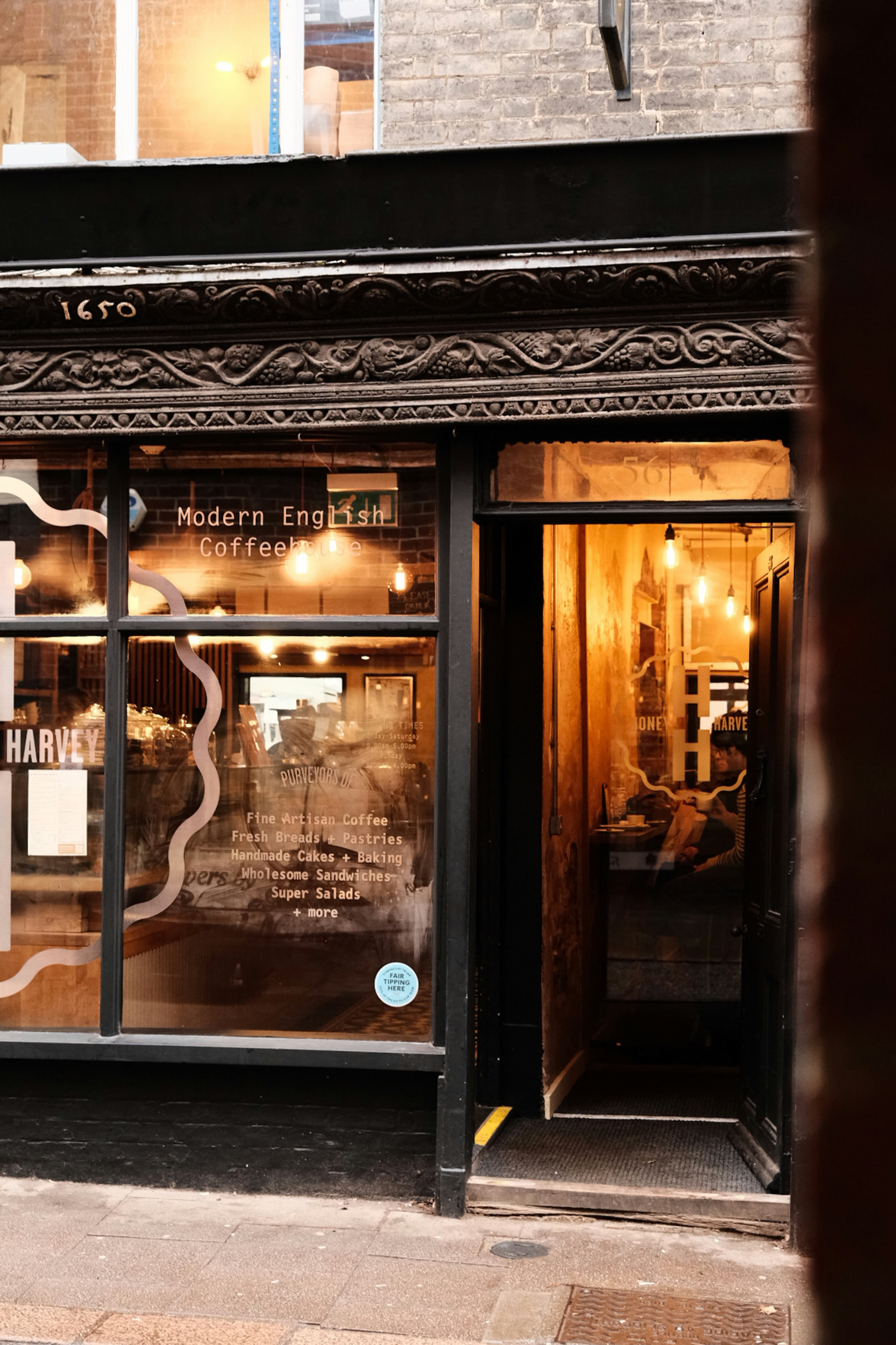 A traditional shop front with a clock on a British high street