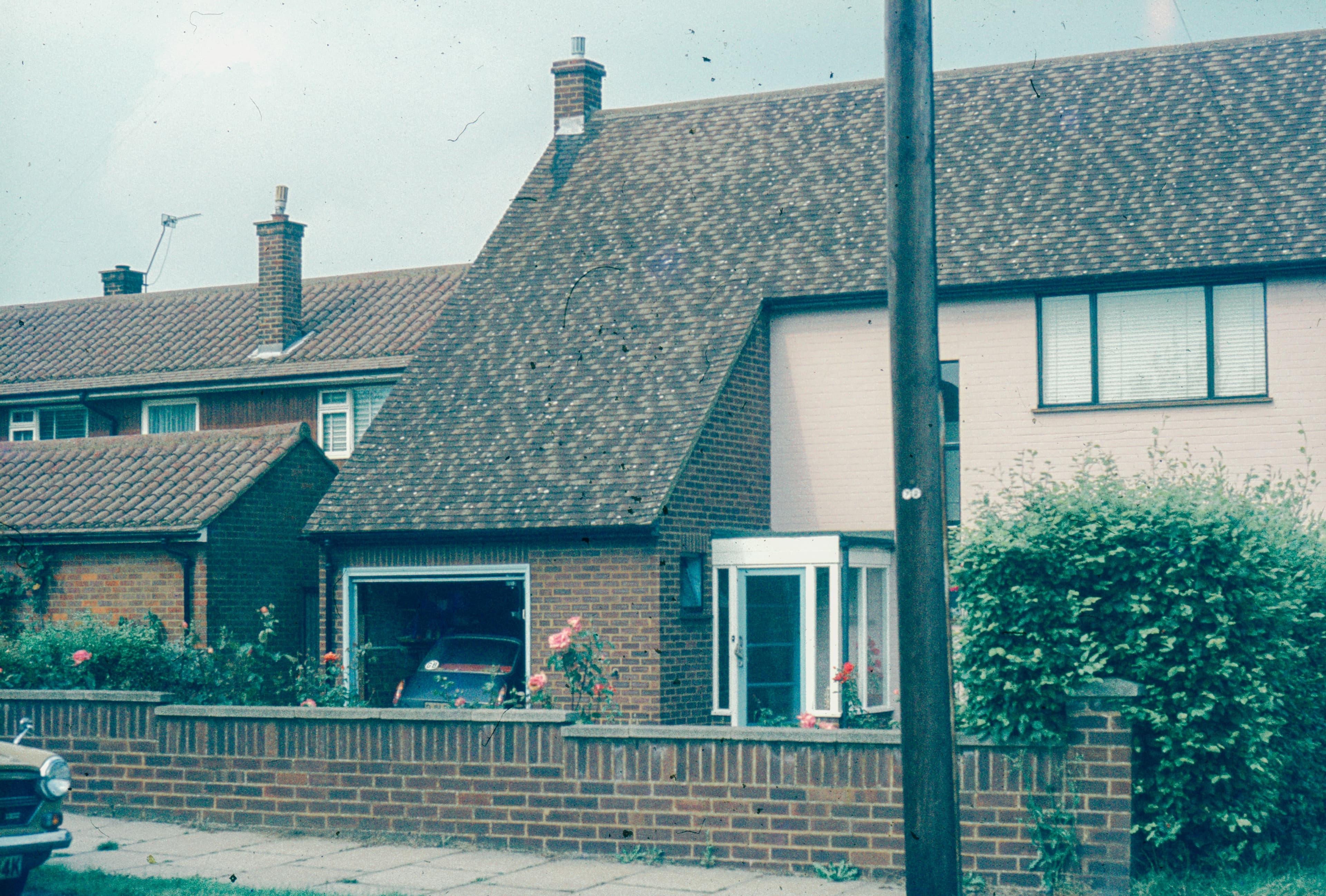 A residential house with a garage on a quiet street
