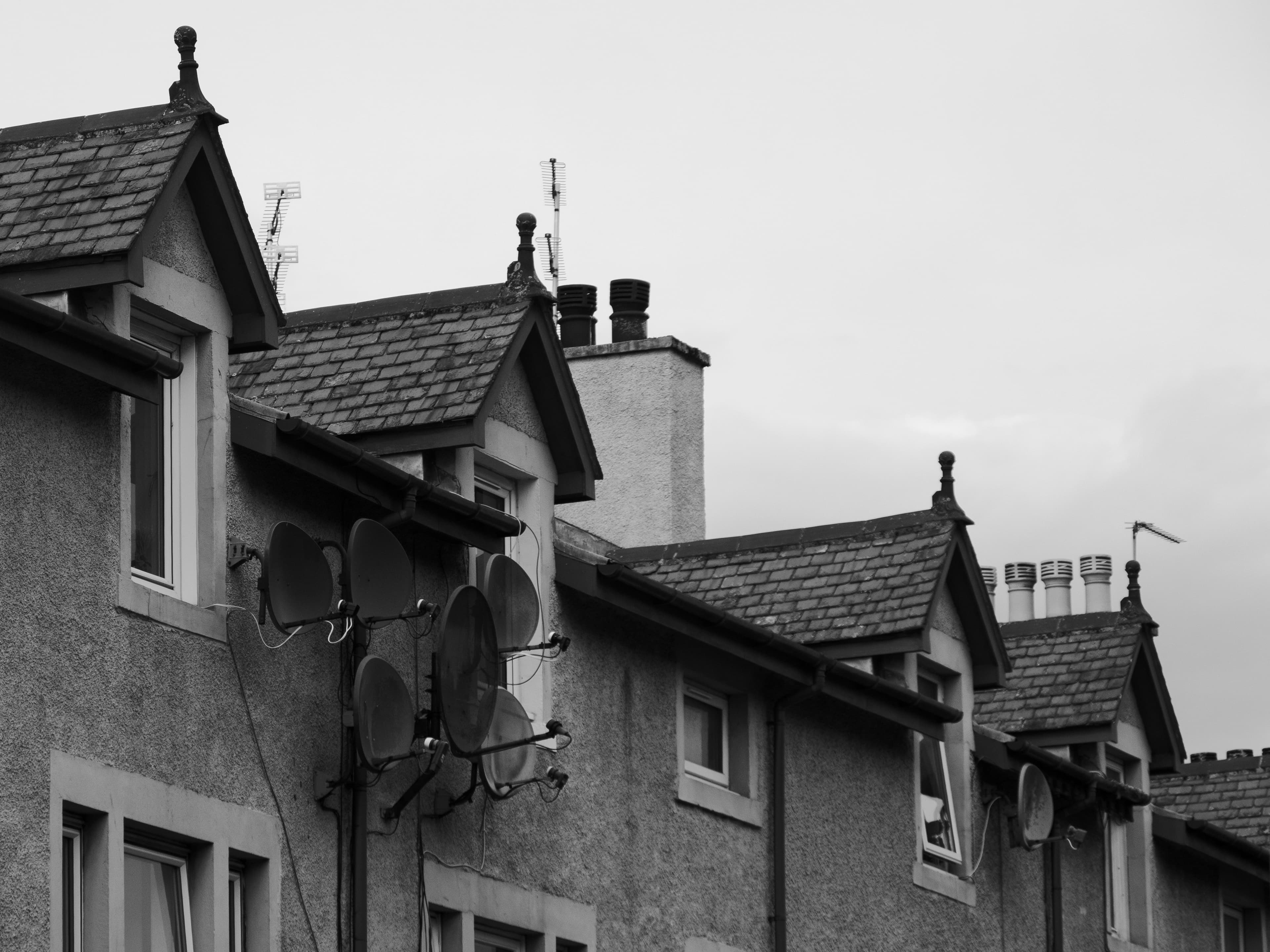 A row of houses with gabled roofs along a residential street