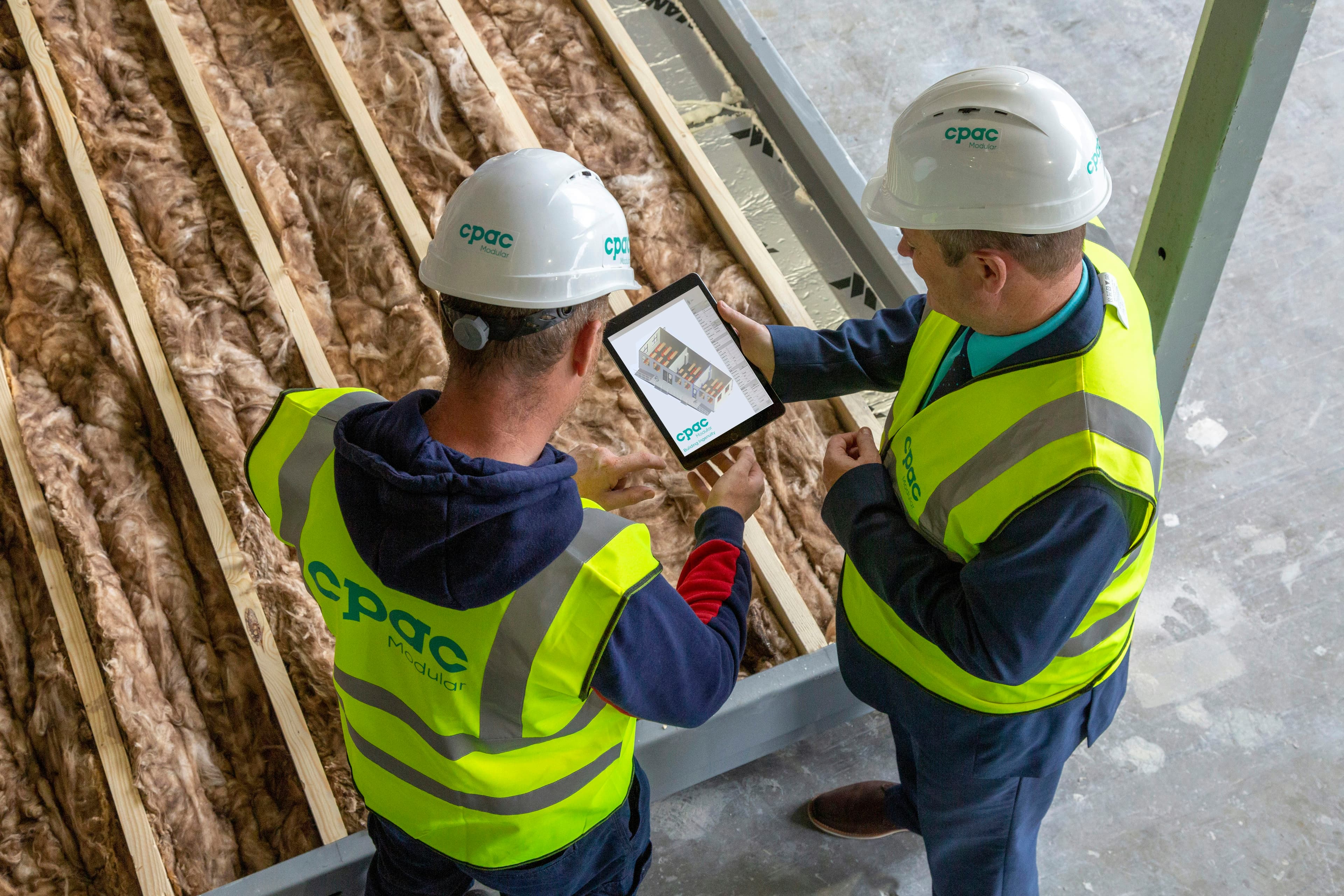 Two people reviewing plans together on a tablet