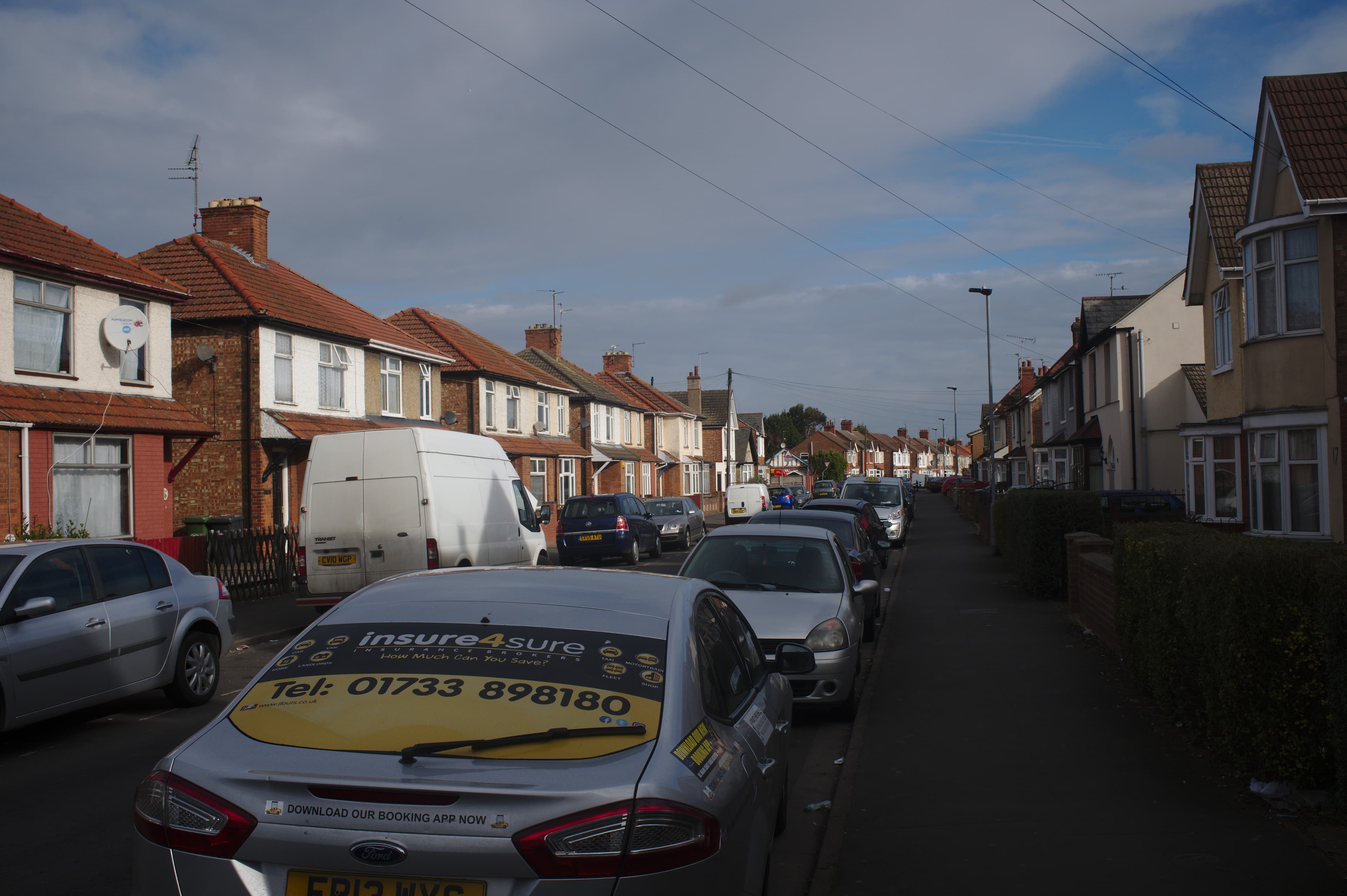 An ordinary suburban residential street of houses in England with no for sale boards visible