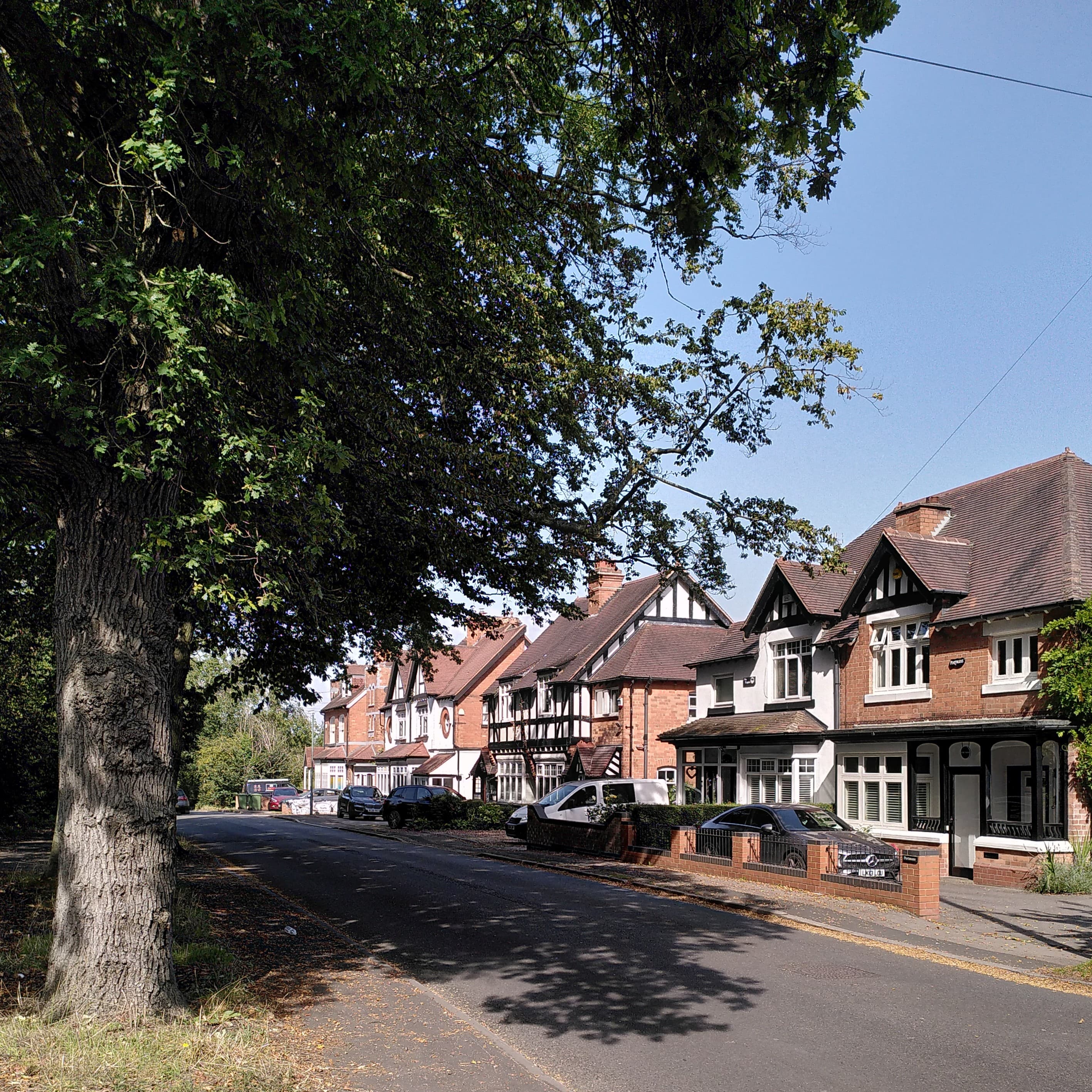A row of ordinary suburban houses on an English residential street