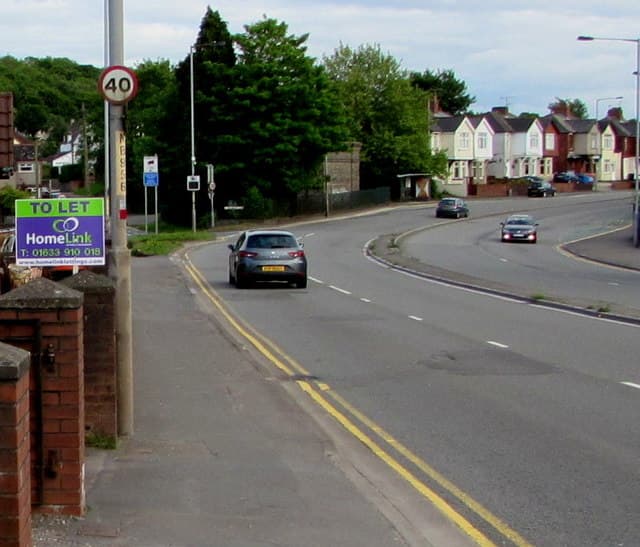A letting agent's To Let board outside a residential property on a UK street