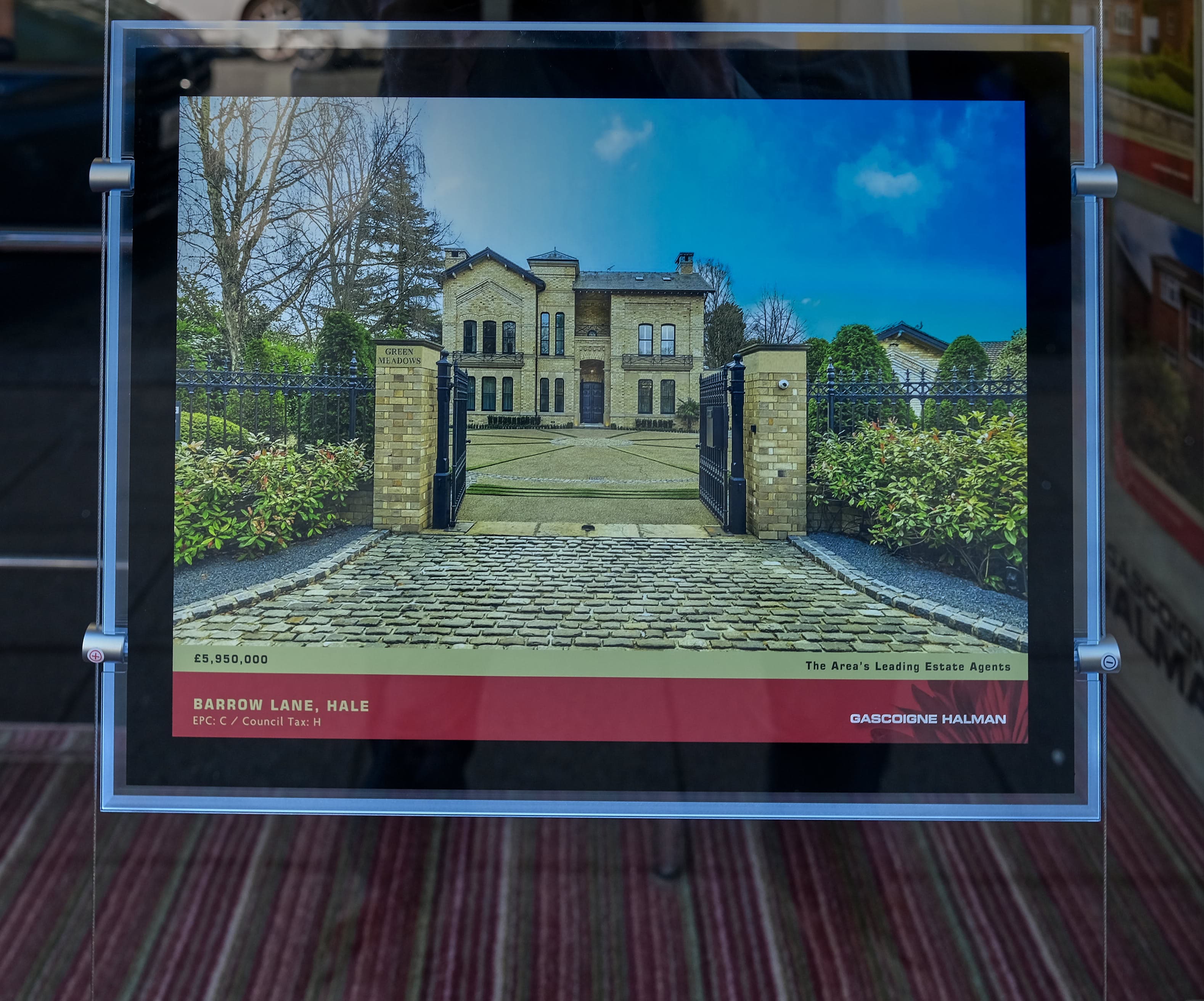 An estate agent's window filled with property listings, standing for supply and demand in the housing market