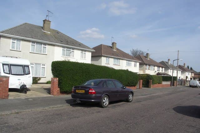 A pair of near-identical semi-detached houses side by side on an English street