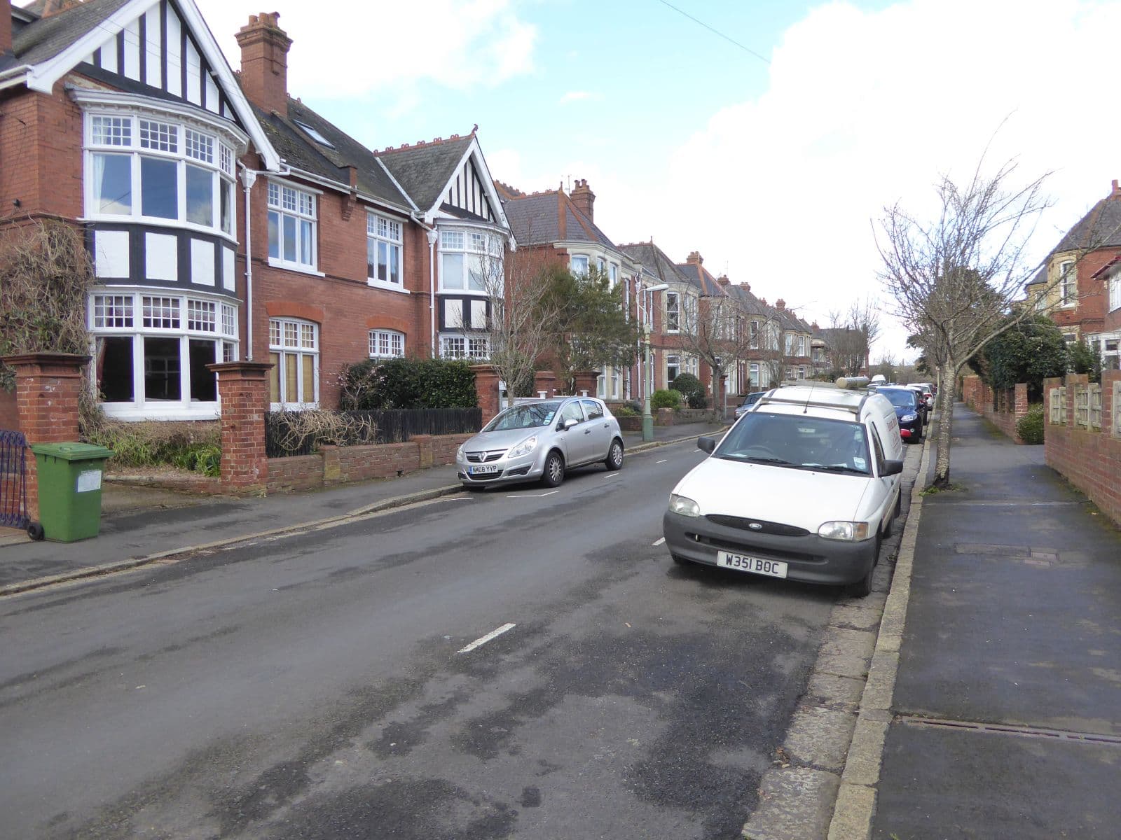 A pair of semi-detached houses on a residential road in Exeter