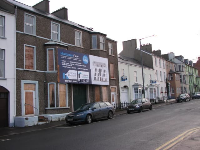 For sale signs outside houses on a sunny street in Portrush