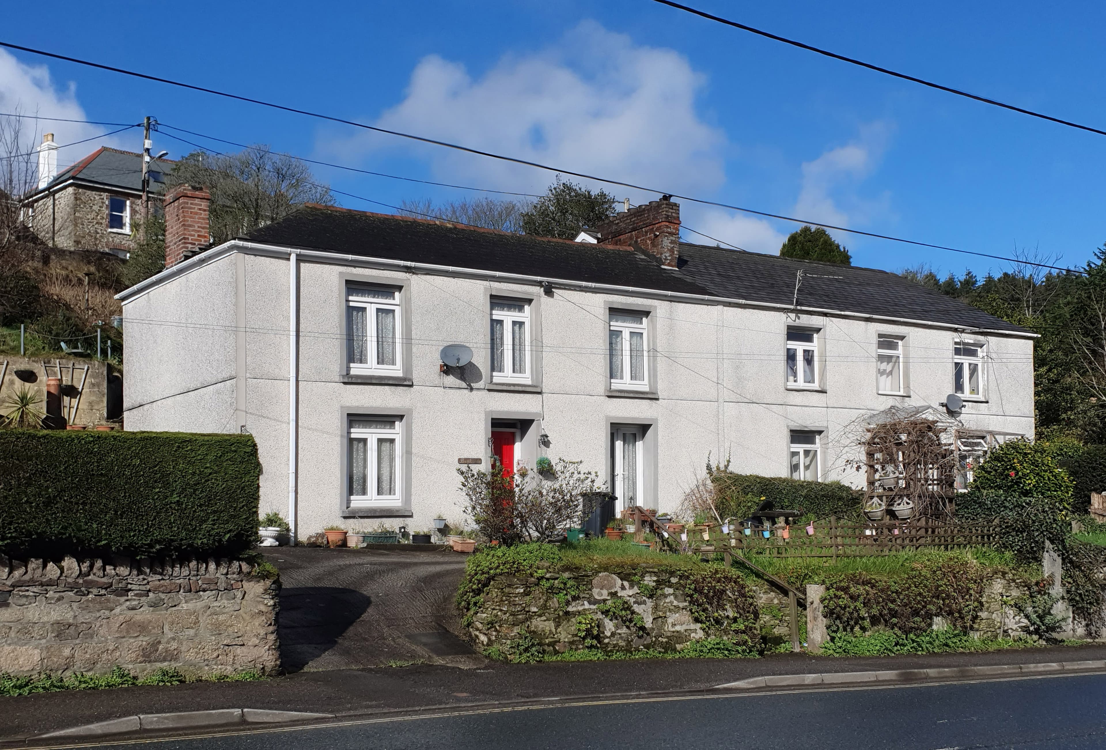 A pair of semi-detached houses on a residential street in England, the kind of home a survey renegotiation often concerns