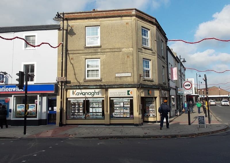 A UK high street estate agents office window displaying properties for sale