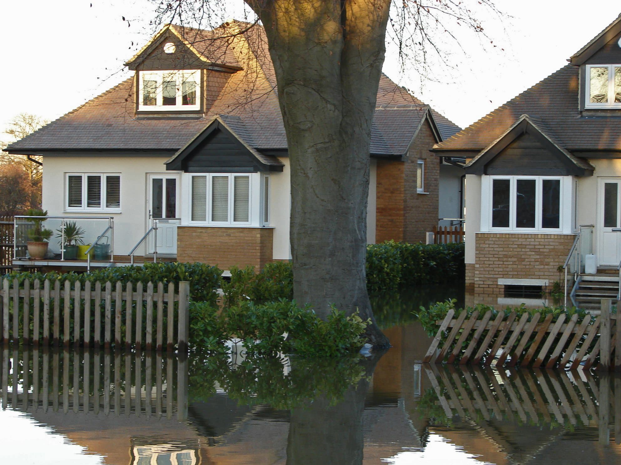 Floodwater surrounding houses on a residential street in Chertsey, Surrey