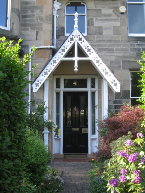A garden path leading to the porch and front door of a house