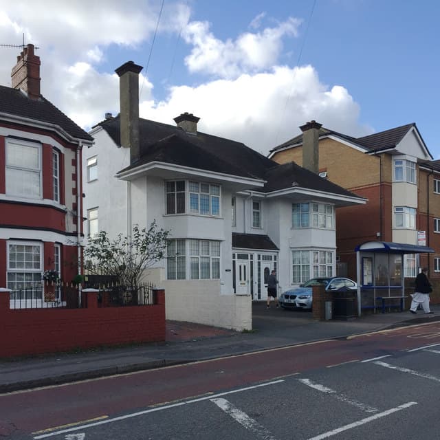 A pair of 1930s semi-detached houses on a British suburban road